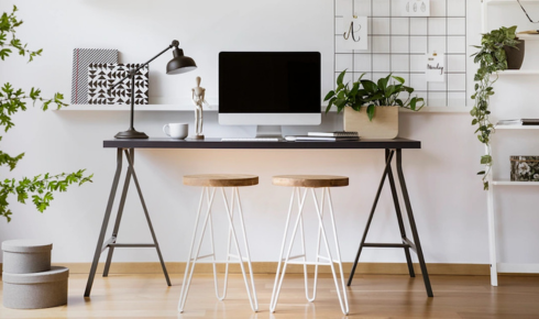 How can placing a small plant on a work desk make the area feel less stressful?