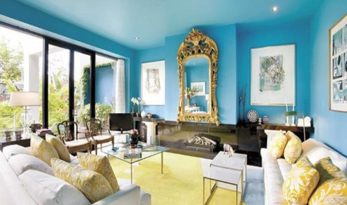 How can painting ceilings a very light shade instead of pure white soften harsh lighting?