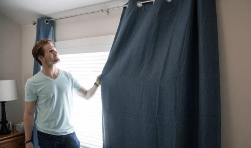 How can teaching family members to close curtains at night reduce outside visibility into your home?