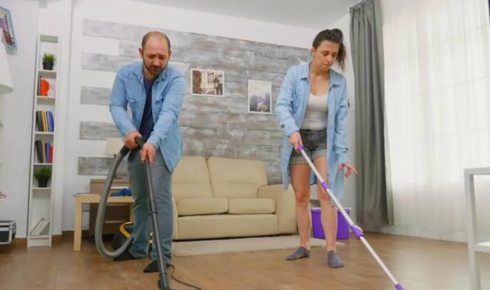How can vacuuming or sweeping under beds once in a while reduce dust-related sneezing?