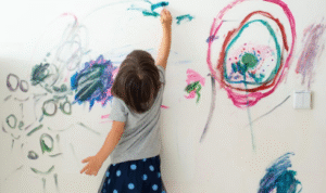 What benefit is there in using stain-resistant paint near kids’ study tables and craft areas?